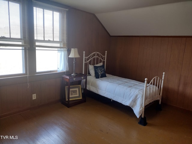 bedroom featuring lofted ceiling and dark wood-type flooring