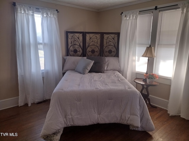 bedroom with ornamental molding and dark wood-type flooring