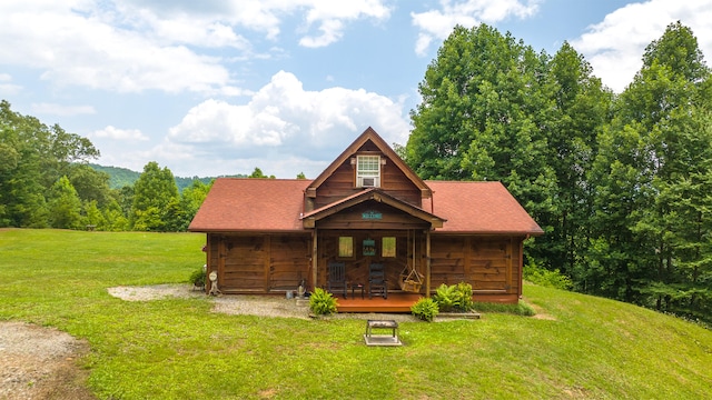 log home featuring a front lawn