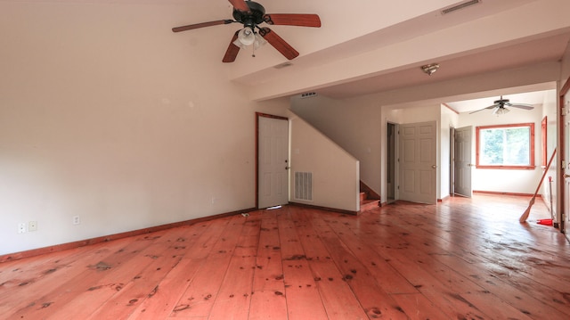 unfurnished living room featuring ceiling fan and hardwood / wood-style flooring