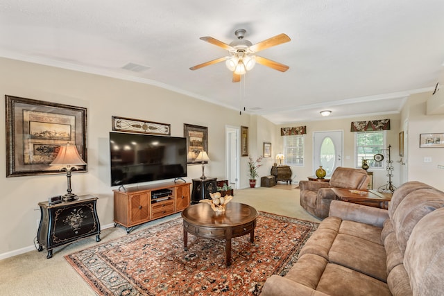 living room featuring light colored carpet, ornamental molding, and ceiling fan