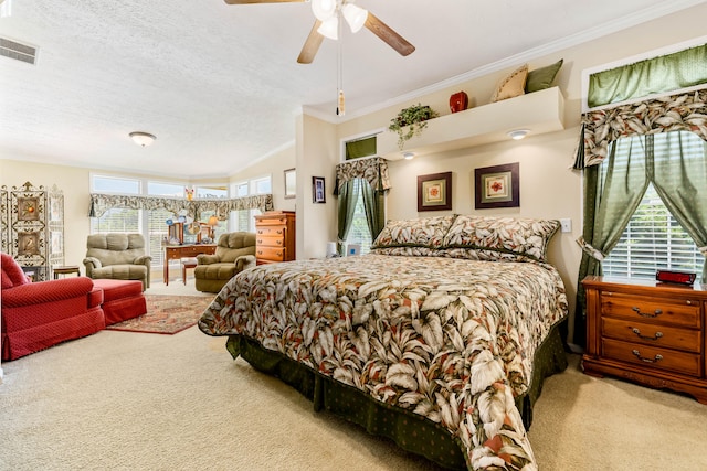 carpeted bedroom with ceiling fan, a textured ceiling, and crown molding