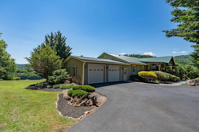 ranch-style house featuring a front lawn and a garage