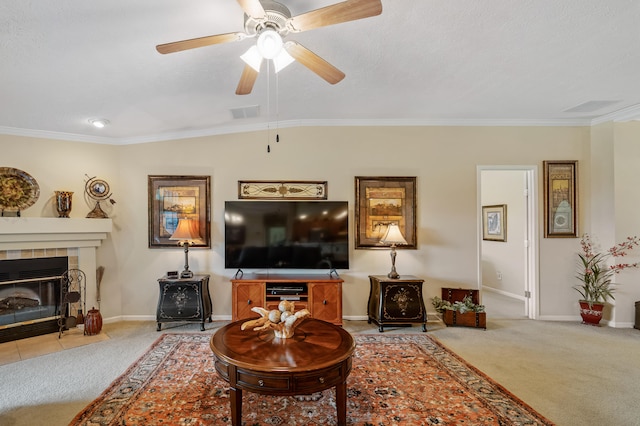 living room featuring light colored carpet, a tile fireplace, ceiling fan, ornamental molding, and lofted ceiling