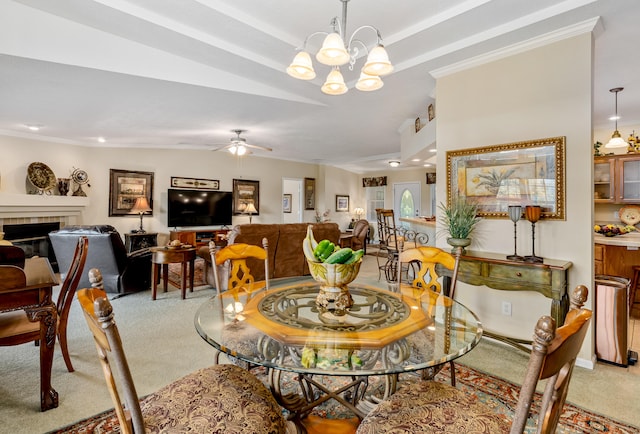 dining area with light colored carpet, ceiling fan with notable chandelier, and a fireplace