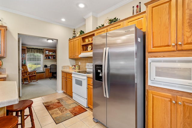 kitchen featuring backsplash, white appliances, light tile floors, and crown molding