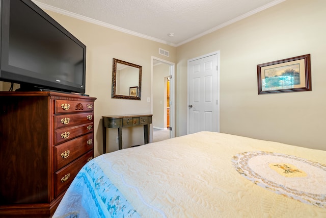 bedroom with a textured ceiling and ornamental molding