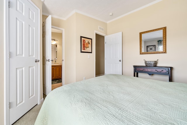 carpeted bedroom featuring connected bathroom and ornamental molding