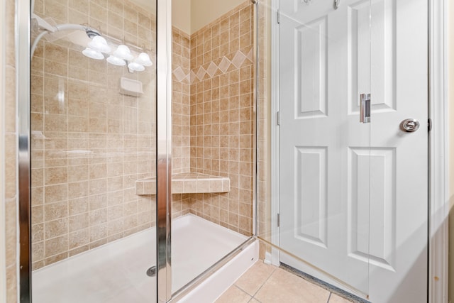 bathroom featuring tile floors and an enclosed shower