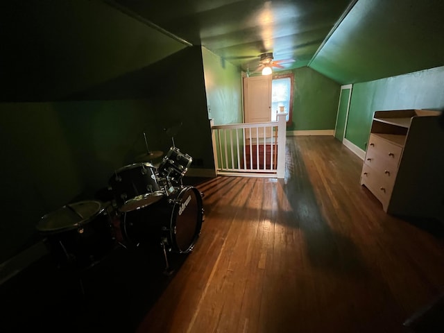 bonus room with vaulted ceiling, ceiling fan, and dark hardwood / wood-style flooring