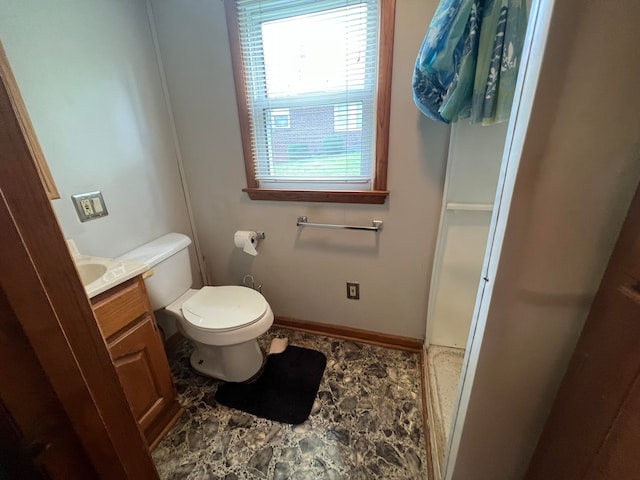 bathroom with toilet, tile floors, and vanity