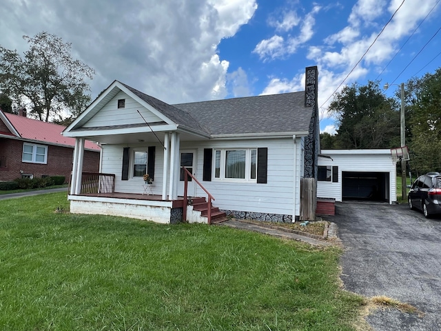 bungalow-style home featuring a front yard, covered porch, and a garage