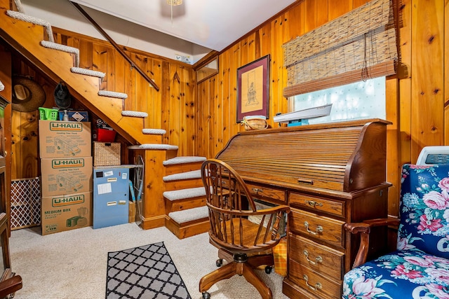 home office featuring wood walls and carpet