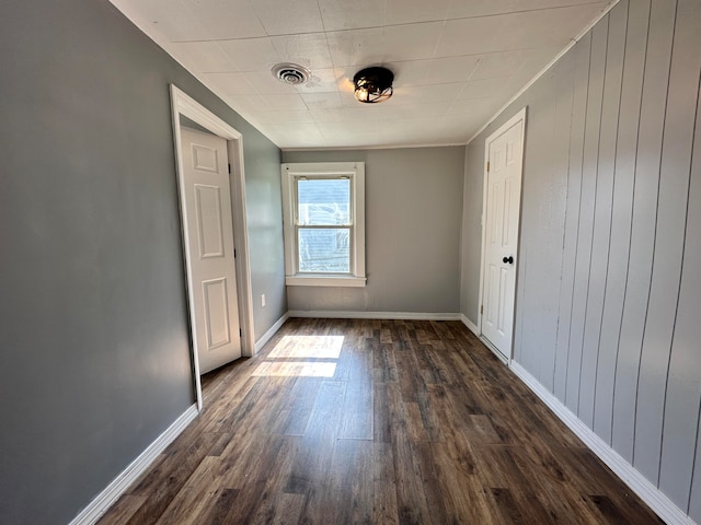 unfurnished room featuring ornamental molding and dark hardwood / wood-style flooring