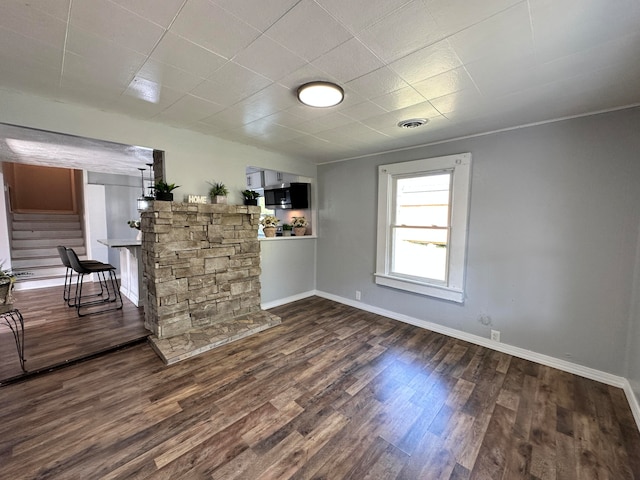 unfurnished room with dark wood-type flooring