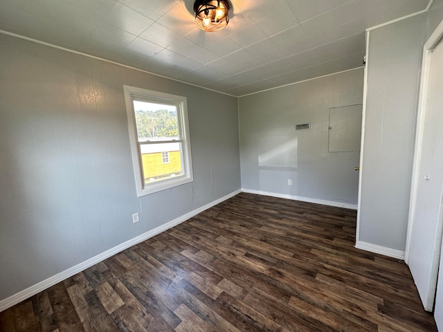 spare room featuring dark wood-type flooring