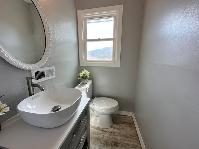 bathroom featuring toilet and vanity