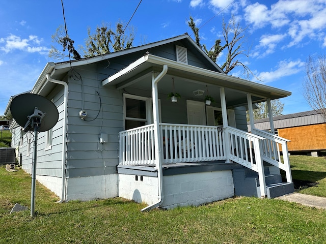 exterior space featuring central AC, a lawn, and a porch