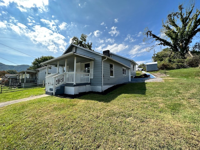 view of front of property with covered porch and a front yard