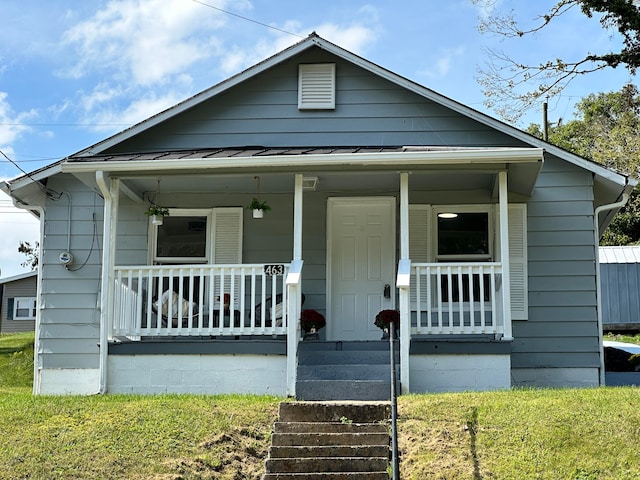 bungalow with a front lawn and a porch