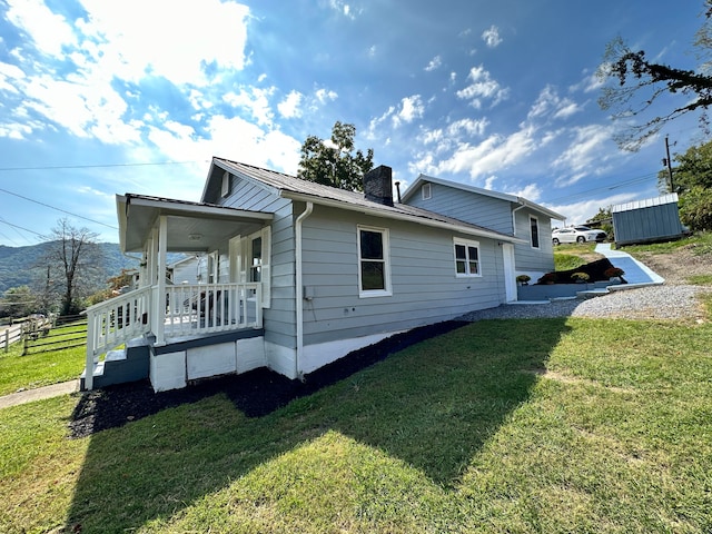 view of side of home with a yard