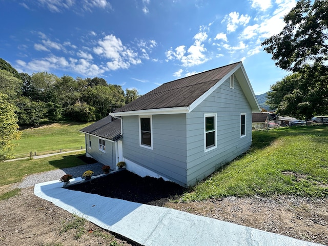 view of side of property with a lawn