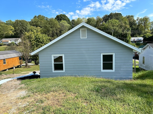 view of property exterior with a yard