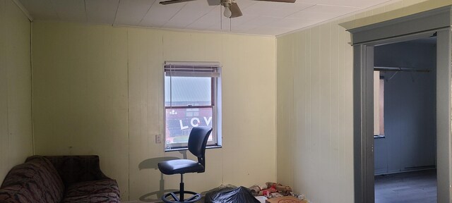 sitting room with ceiling fan and hardwood / wood-style flooring