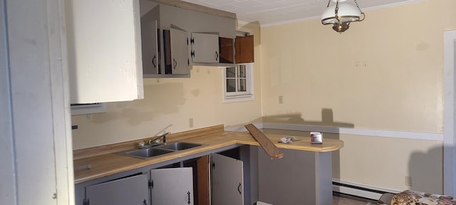 kitchen with crown molding, sink, and a baseboard radiator