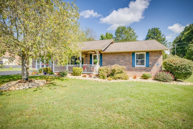 view of front of house with a front yard and covered porch