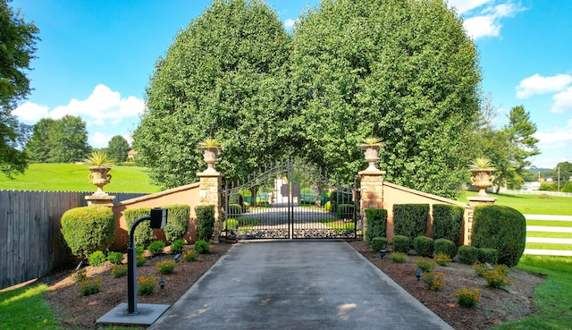 view of gate with a yard