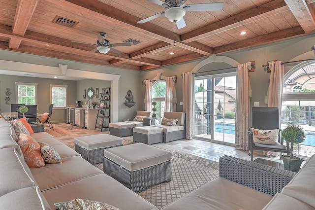 living room with wooden ceiling, ceiling fan, beamed ceiling, and plenty of natural light