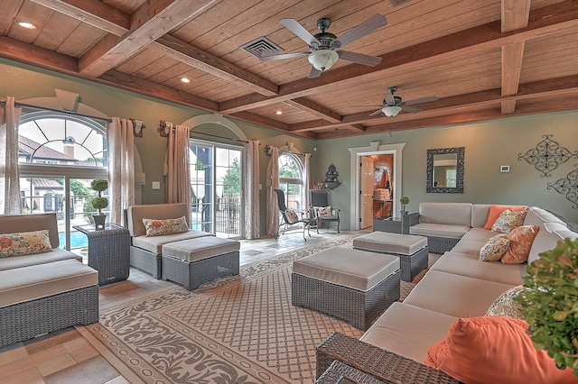 tiled living room with ceiling fan, wood ceiling, a wealth of natural light, and beam ceiling