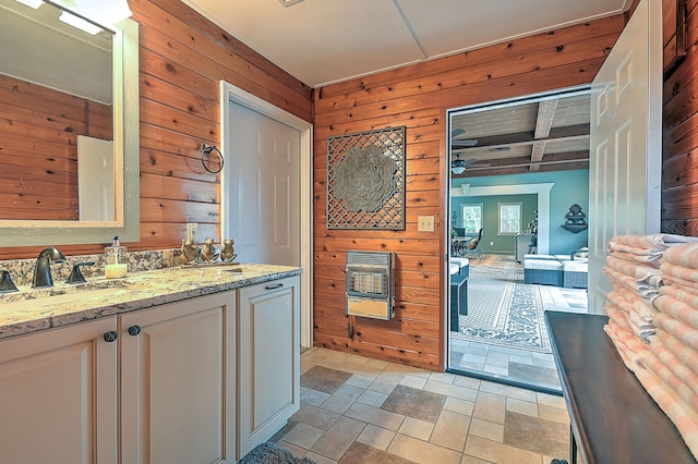 bathroom featuring coffered ceiling, tile floors, vanity, and wooden walls