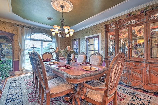 dining room with ornamental molding, a chandelier, and wood-type flooring