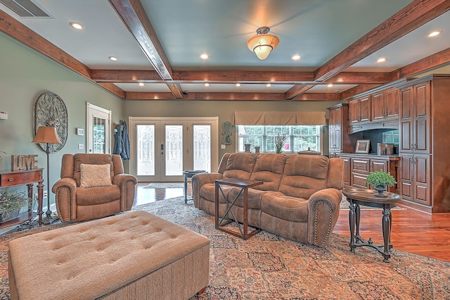 living room with coffered ceiling, french doors, light hardwood / wood-style flooring, and beamed ceiling