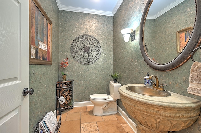 bathroom with tile flooring, ornamental molding, toilet, and sink