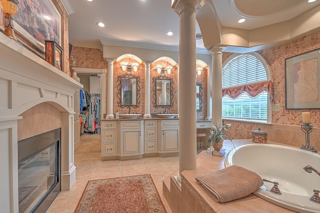 bathroom featuring ornate columns, crown molding, tile flooring, vanity, and tiled bath