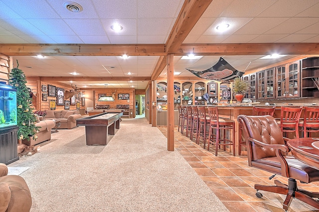 wine cellar with a paneled ceiling, indoor bar, and light tile flooring