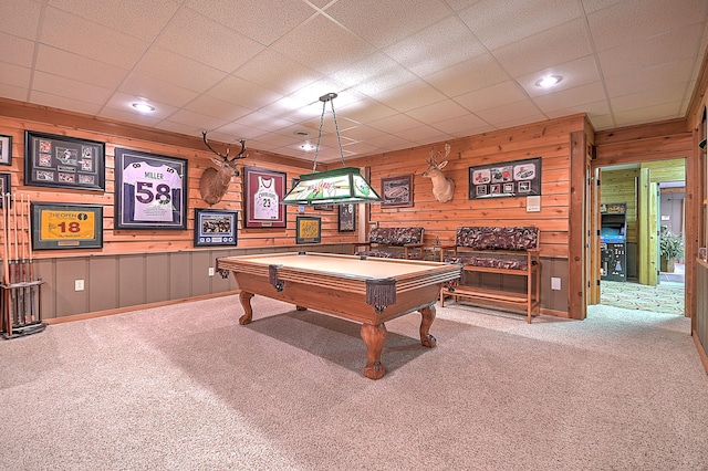 game room featuring wooden walls, a paneled ceiling, light carpet, and billiards