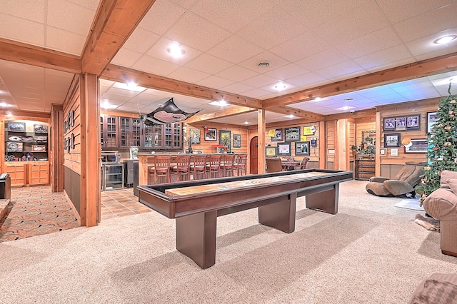 recreation room with light colored carpet and a paneled ceiling