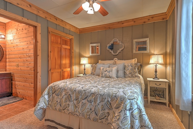 carpeted bedroom with ceiling fan and a closet