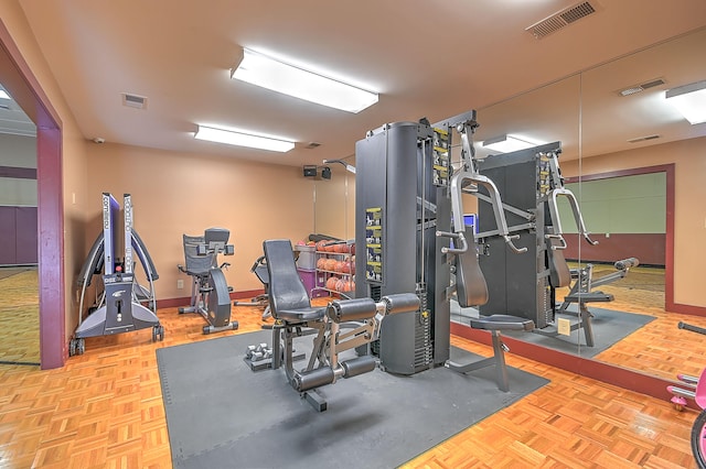 workout room featuring light parquet flooring