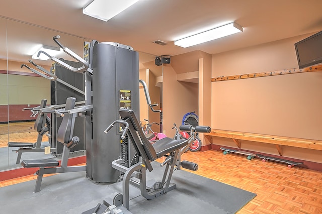 exercise room with light parquet flooring