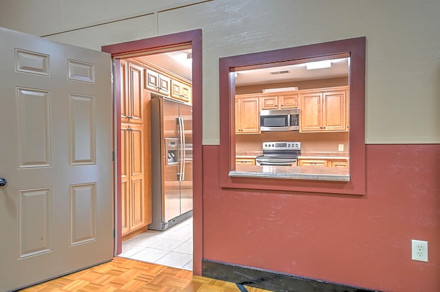 interior space featuring light parquet flooring and stainless steel appliances