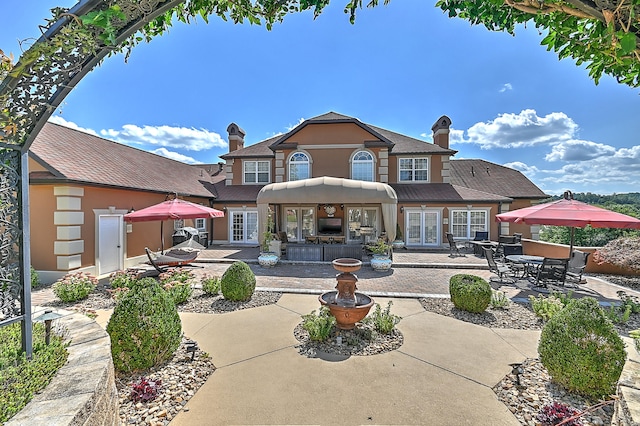 view of front facade featuring a patio and french doors