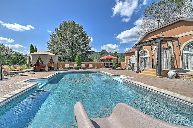 view of swimming pool with a patio and a pergola