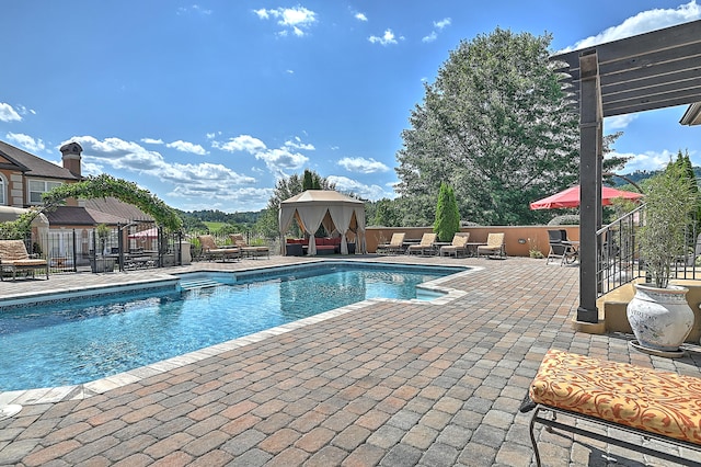 view of pool with a patio and a gazebo