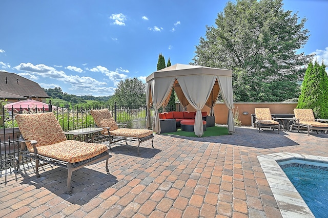 view of patio with outdoor lounge area, a gazebo, and a fenced in pool