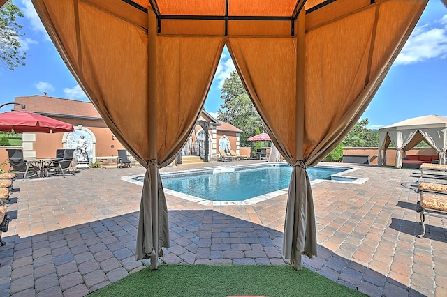 view of pool featuring a gazebo and a patio area